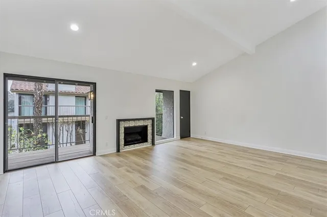 wooden floor in an empty room with a fireplace