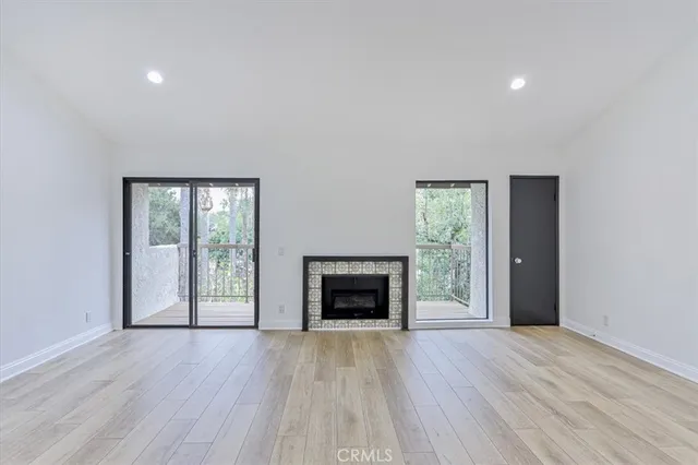 wooden floor fireplace and natural light in room