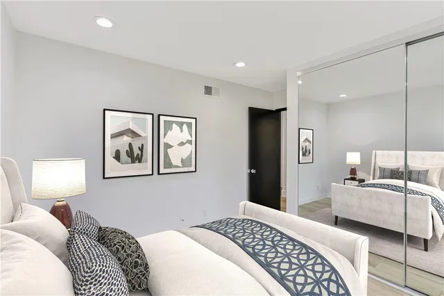 a bedroom with a bed and a lamp