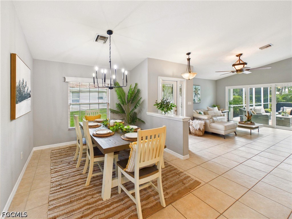19694 Villa Rosa Loop Estero, FL 33967 - Photo 8 of 28 a dining room with furniture a chandelier and window