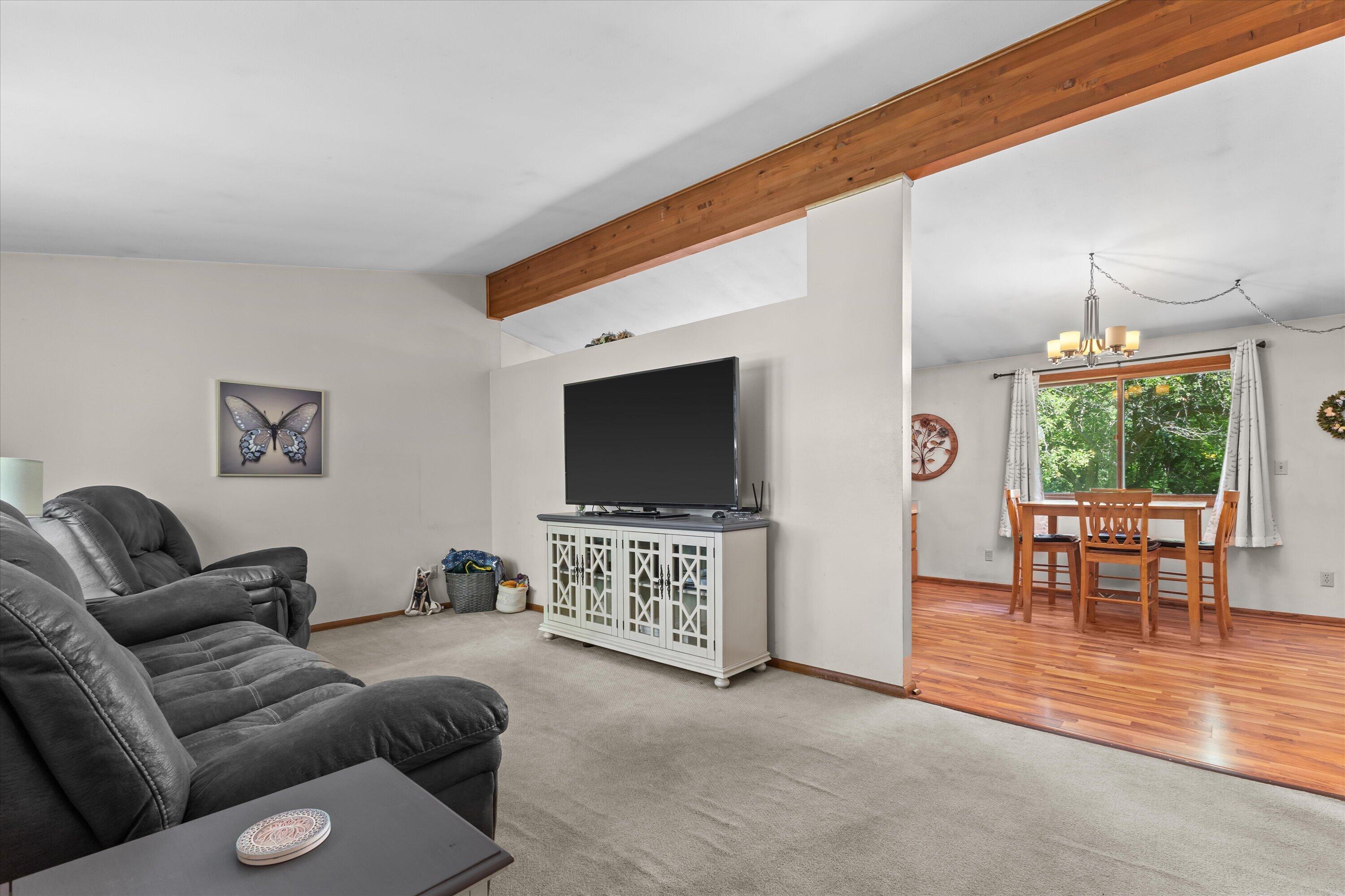 W347S7680 Sprague Road Eagle, WI 53119 - Photo 12 of 45 Living Room Features Vaulted Ceilings With Large Beam