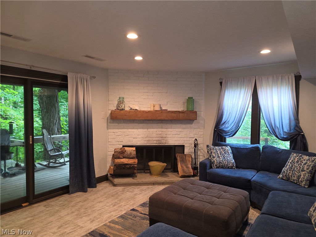 2868 Shade Road Akron, OH 44333 - Photo 36 of 49 Living space featuring a whitewashed brick fireplace with a wood mantle, a stone hearth, and recessed lighting