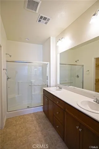a bathroom with a sink a mirror and a shower