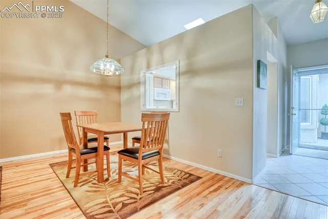 a view of a dining room with furniture and chandelier