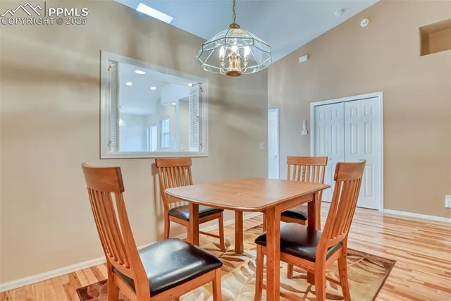 a view of a dining room with furniture a chandelier and wooden floor