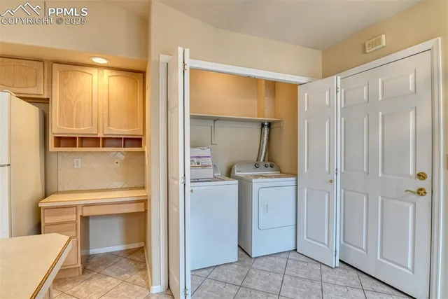 a view of an empty room with window and chandelier