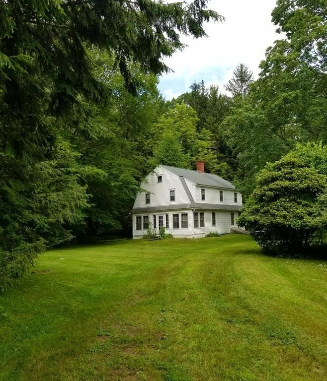 168 Bolton Road Harvard, MA 01451 - Photo 8 of 12 a view of a house with a big yard and large trees