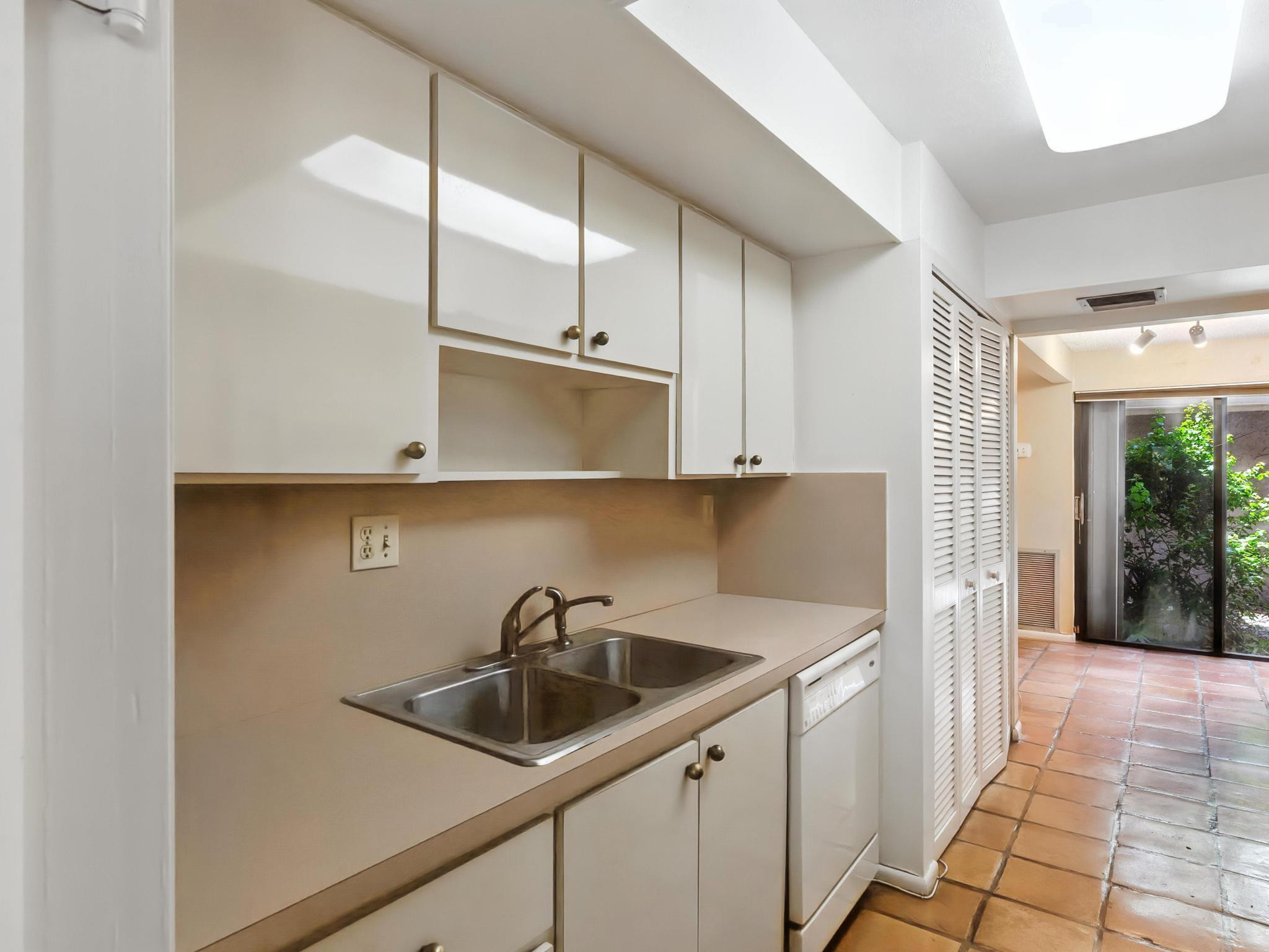 203 Bonnie Brae Way, Unit 34 Hollywood, FL 33021 - Photo 22 of 41 a kitchen with a sink a refrigerator and cabinets