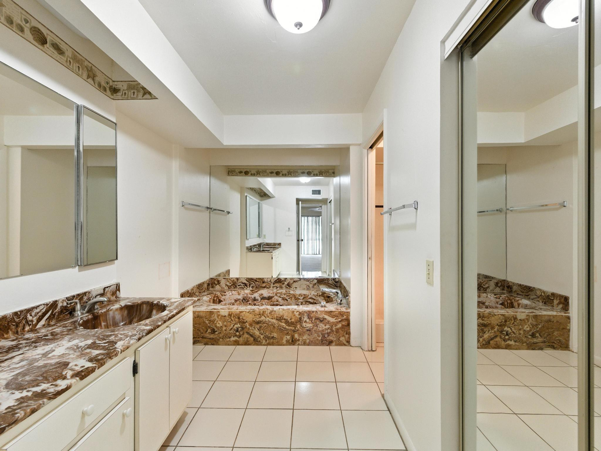 203 Bonnie Brae Way, Unit 34 Hollywood, FL 33021 - Photo 26 of 41 a bathroom with a granite countertop sink and a mirror
