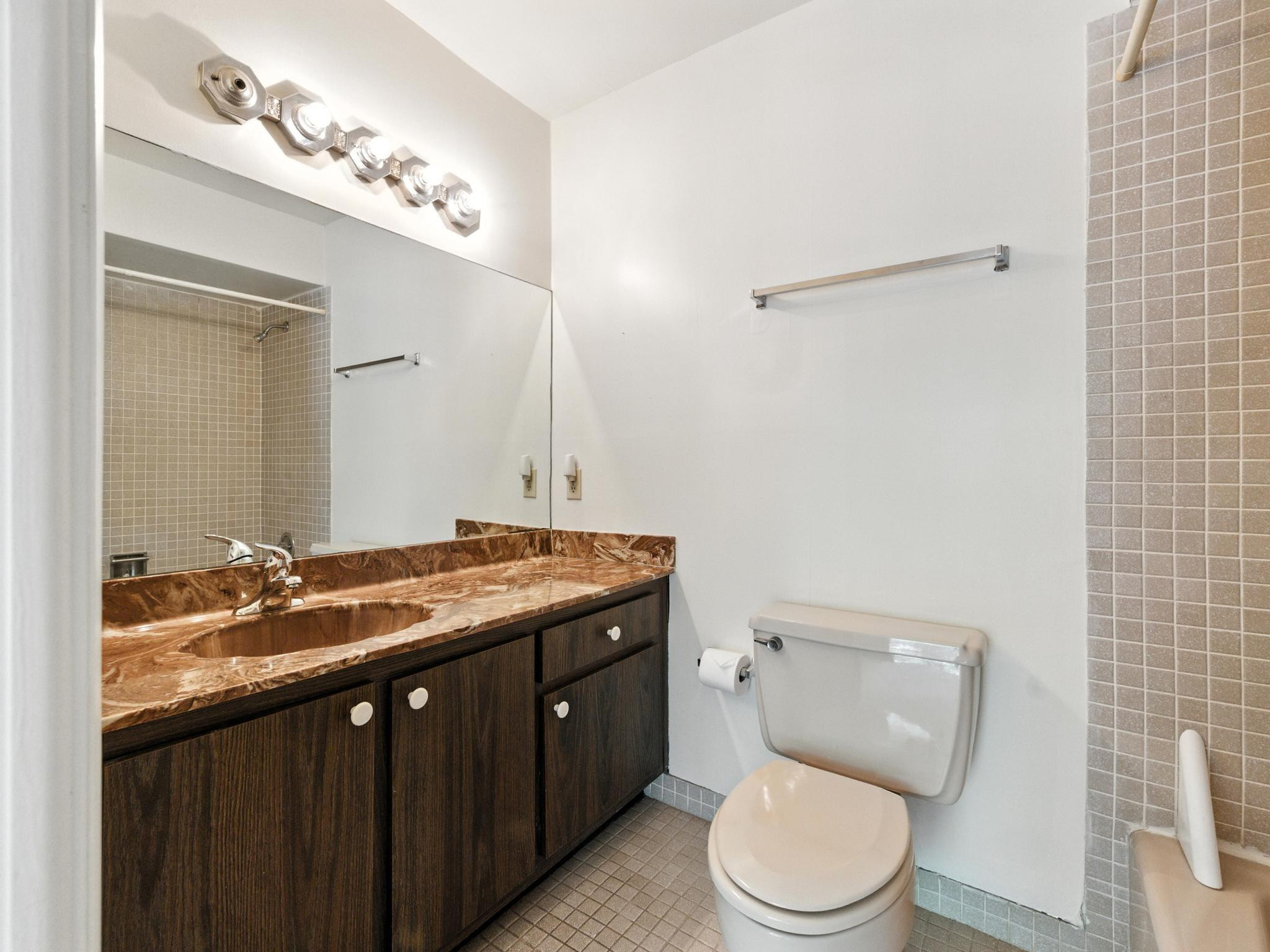 203 Bonnie Brae Way, Unit 34 Hollywood, FL 33021 - Photo 32 of 41 a bathroom with a granite countertop toilet sink and mirror