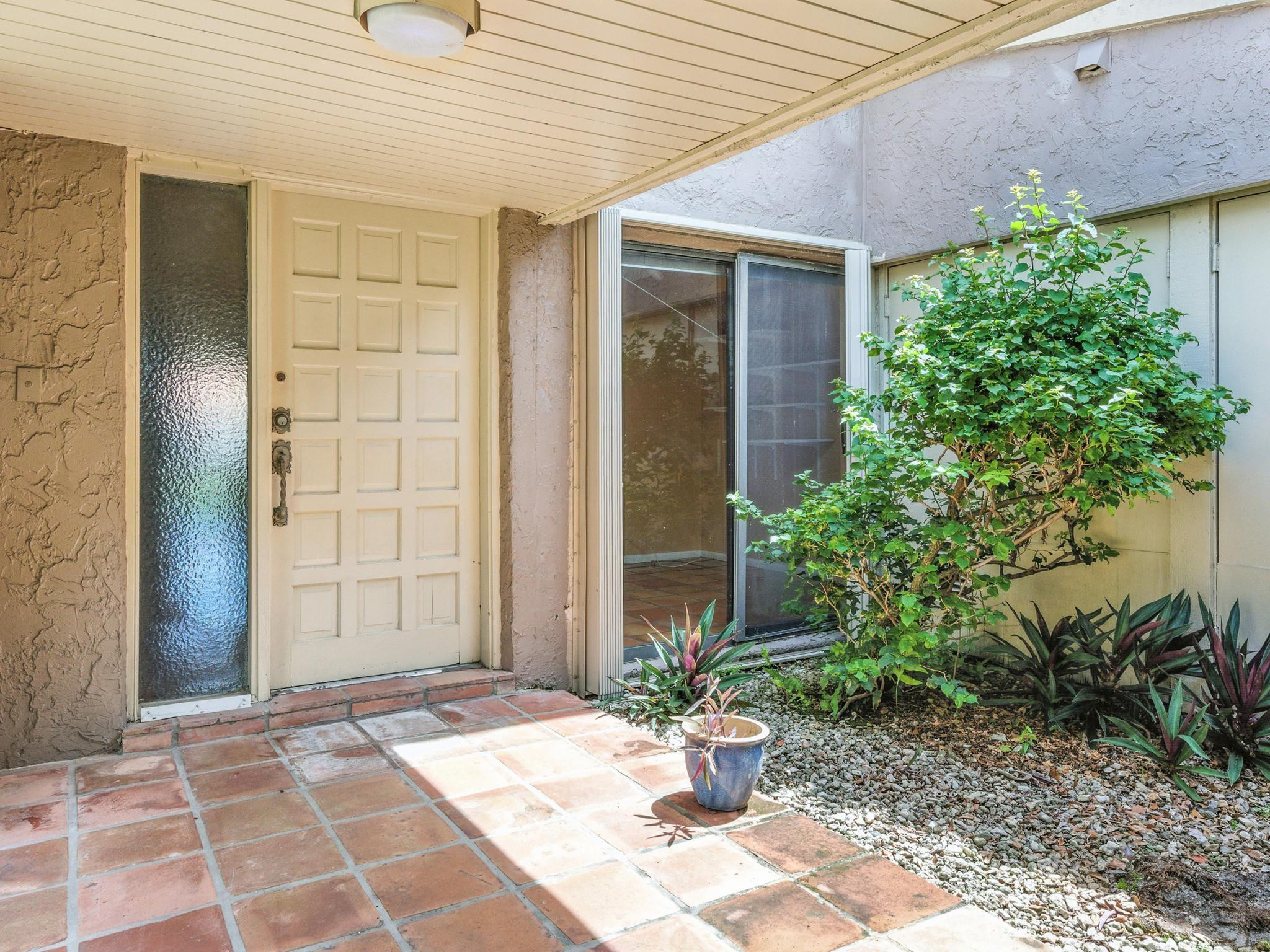 203 Bonnie Brae Way, Unit 34 Hollywood, FL 33021 - Photo 7 of 41 a potted plant sitting in front of a house