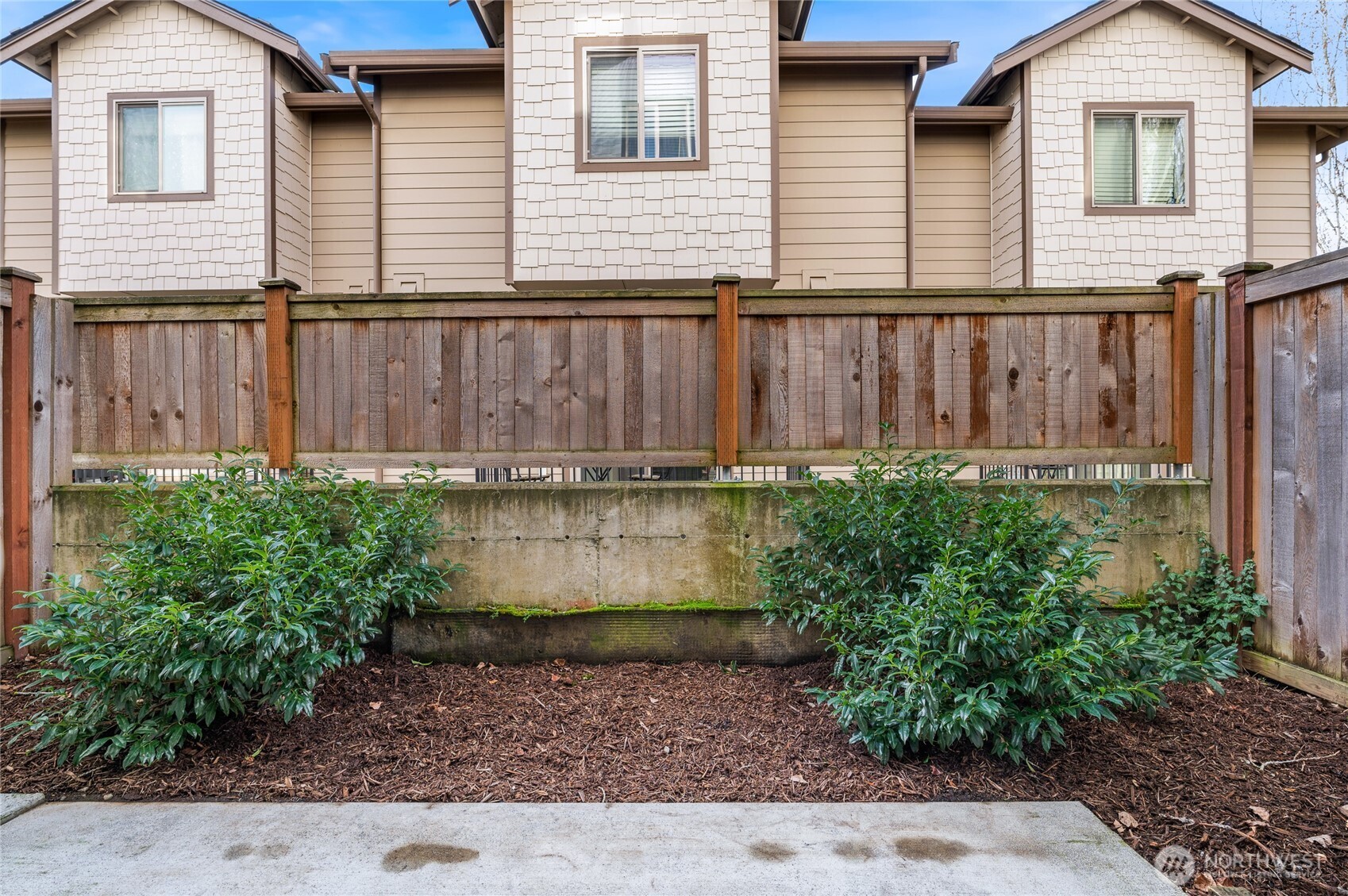 4910 South Willow Street, Unit B Seattle, WA 98118 - Photo 5 of 28 a view of a house with a yard and plants