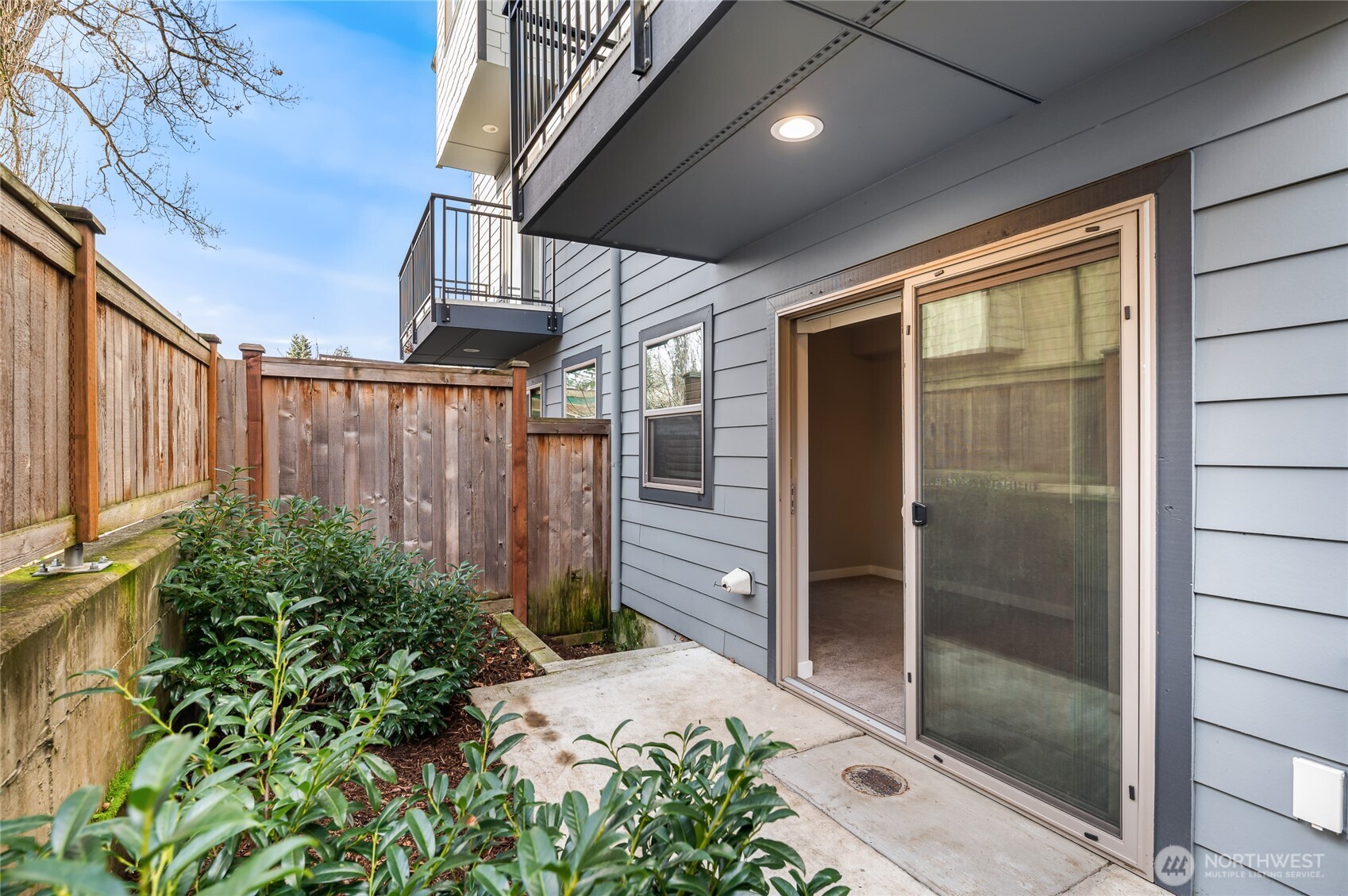 4910 South Willow Street, Unit B Seattle, WA 98118 - Photo 6 of 28 a view of a glass door with a backyard