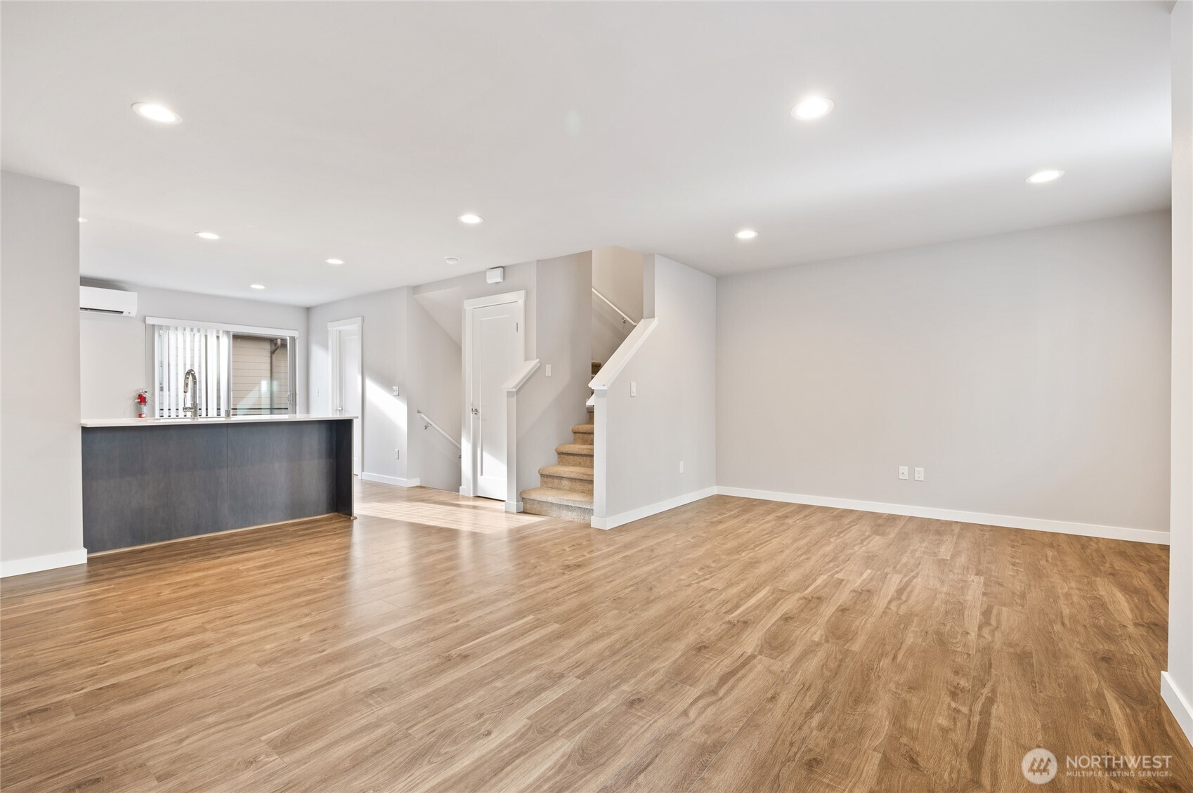 4910 South Willow Street, Unit B Seattle, WA 98118 - Photo 7 of 28 a view of an empty room with wooden floor