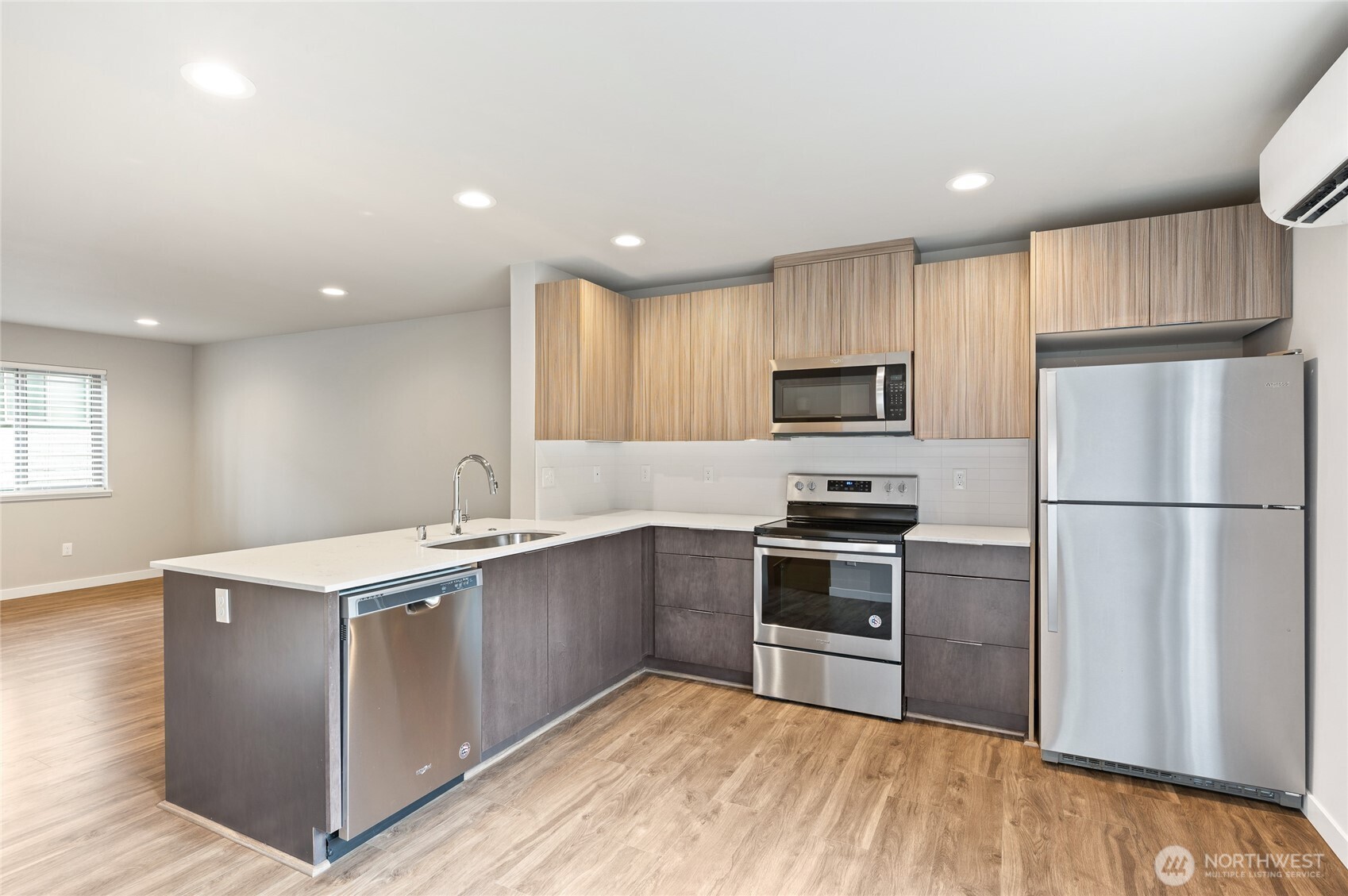 4910 South Willow Street, Unit B Seattle, WA 98118 - Photo 8 of 28 a kitchen with kitchen island a sink stainless steel appliances and cabinets