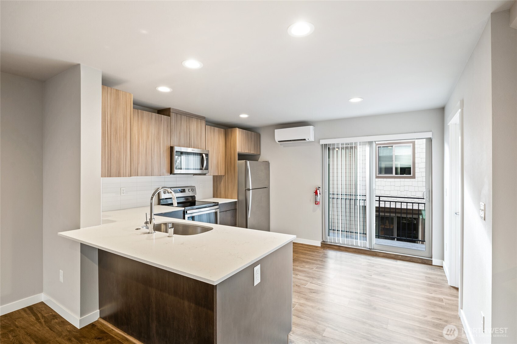 4910 South Willow Street, Unit B Seattle, WA 98118 - Photo 9 of 28 a kitchen with kitchen island a sink cabinets and wooden floor