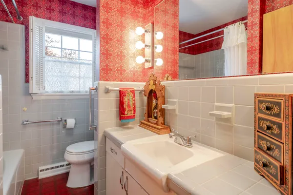 a bathroom with a sink toilet and a mirror