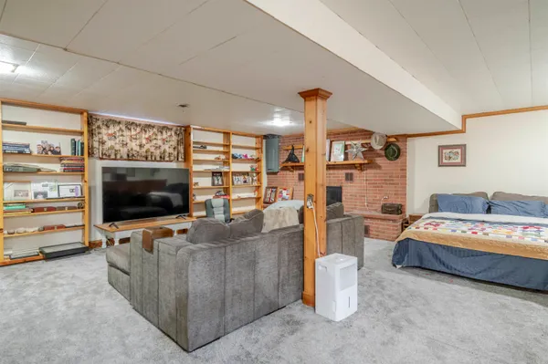 a front view of a house with a yard covered in snow