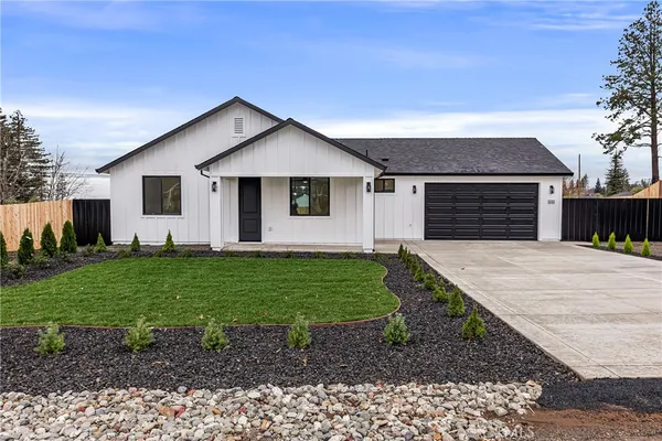 a front view of house with yard and green space