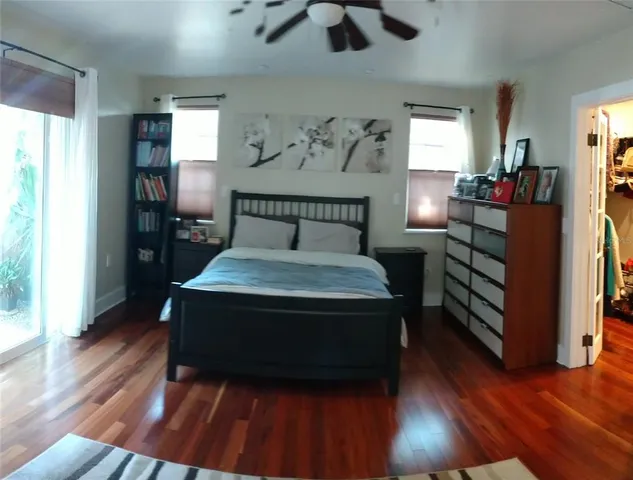 a kitchen with a refrigerator a sink and wooden floor
