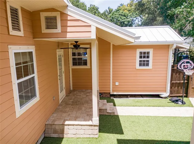 a living room with a couch wooden floor and a window