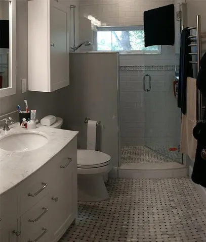 a bed sitting in a bedroom next to a window with wooden floor