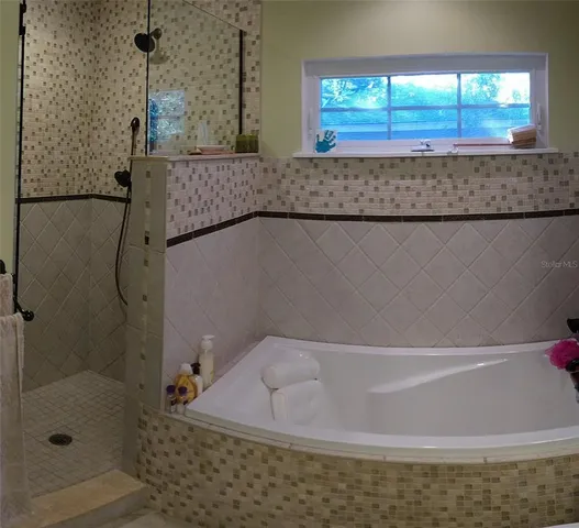 a view of empty room with wooden floor and windows