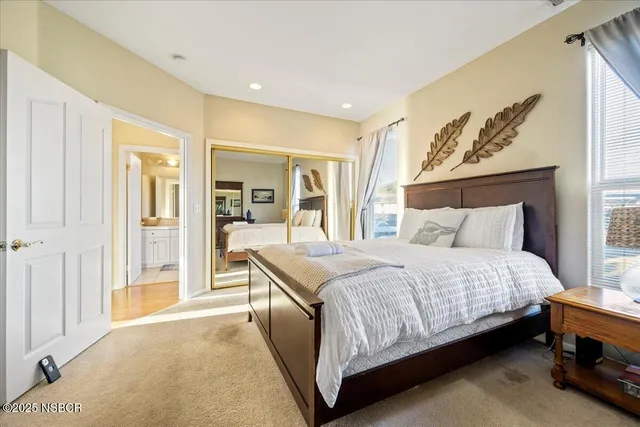 a bedroom with a bed and a mirror