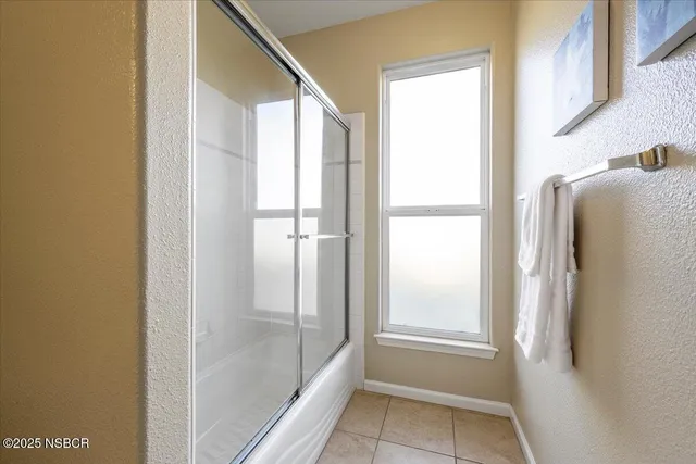 a bathroom with a bathtub and shower