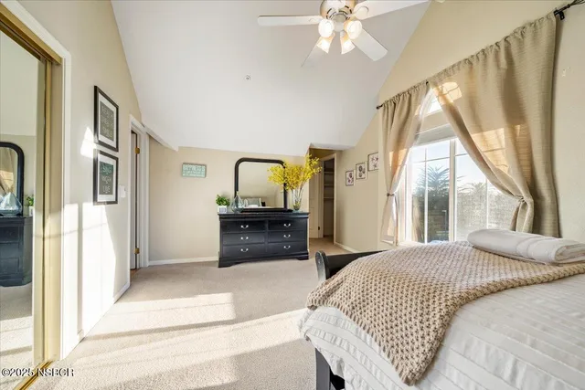 a living room with a bed furniture and a large window