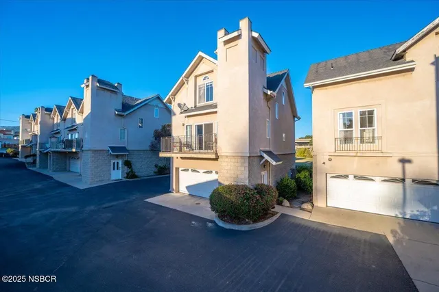 a view of an house with backyard and a kitchen
