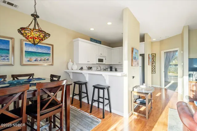 a view of a dining room with furniture wooden floor and chandelier