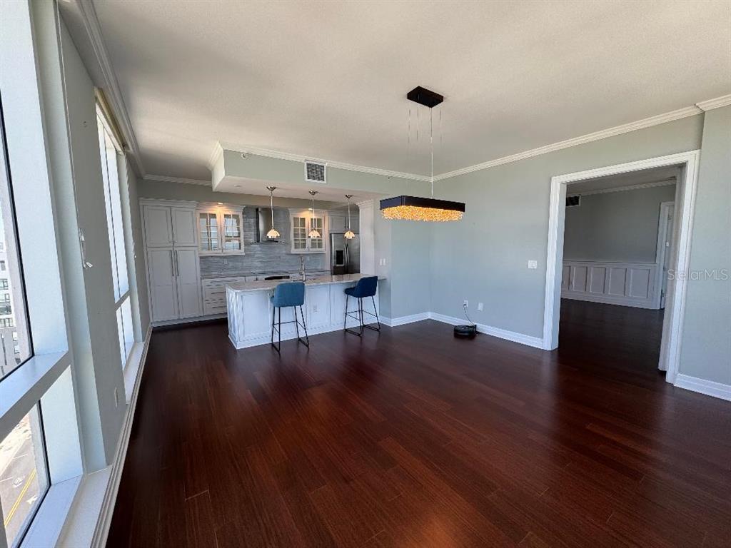 331 Cleveland Street, Unit 1504 Clearwater, FL 33755 - Photo 16 of 46 a view of a furniture and an empty room with wooden floor and a window