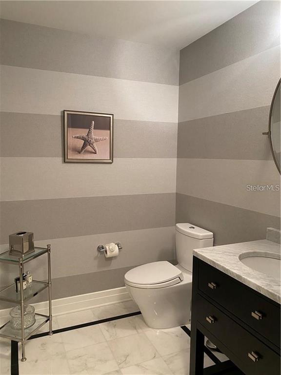 331 Cleveland Street, Unit 1504 Clearwater, FL 33755 - Photo 27 of 46 a bathroom with a toilet a sink and mirror