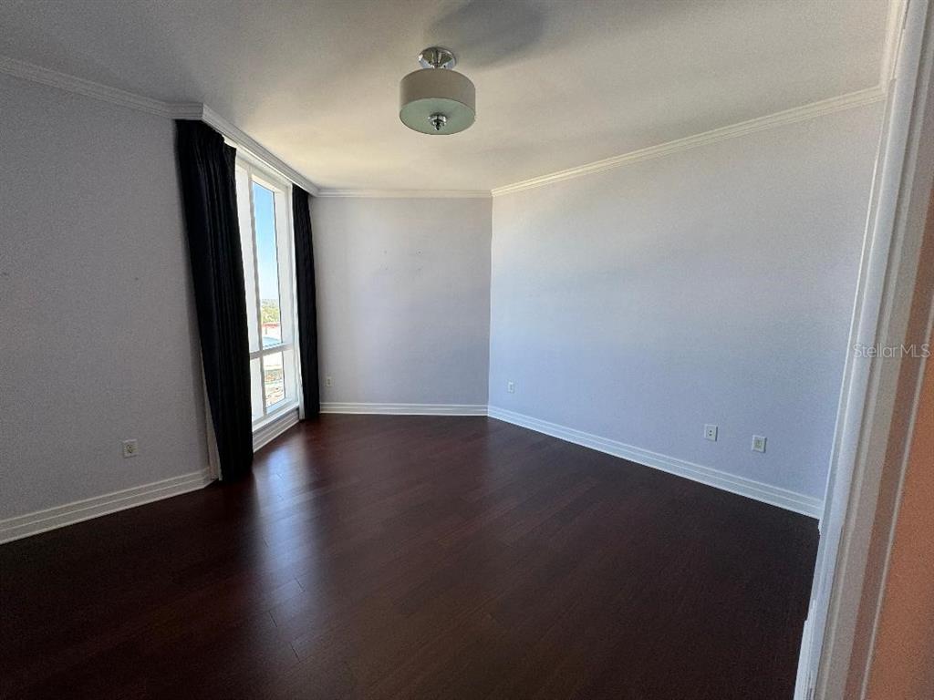 331 Cleveland Street, Unit 1504 Clearwater, FL 33755 - Photo 37 of 46 an empty room with wooden floor and windows