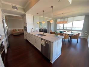 331 Cleveland Street, Unit 1504 Clearwater, FL 33755 - Photo 8 of 46 a kitchen with a stove and a wooden floor