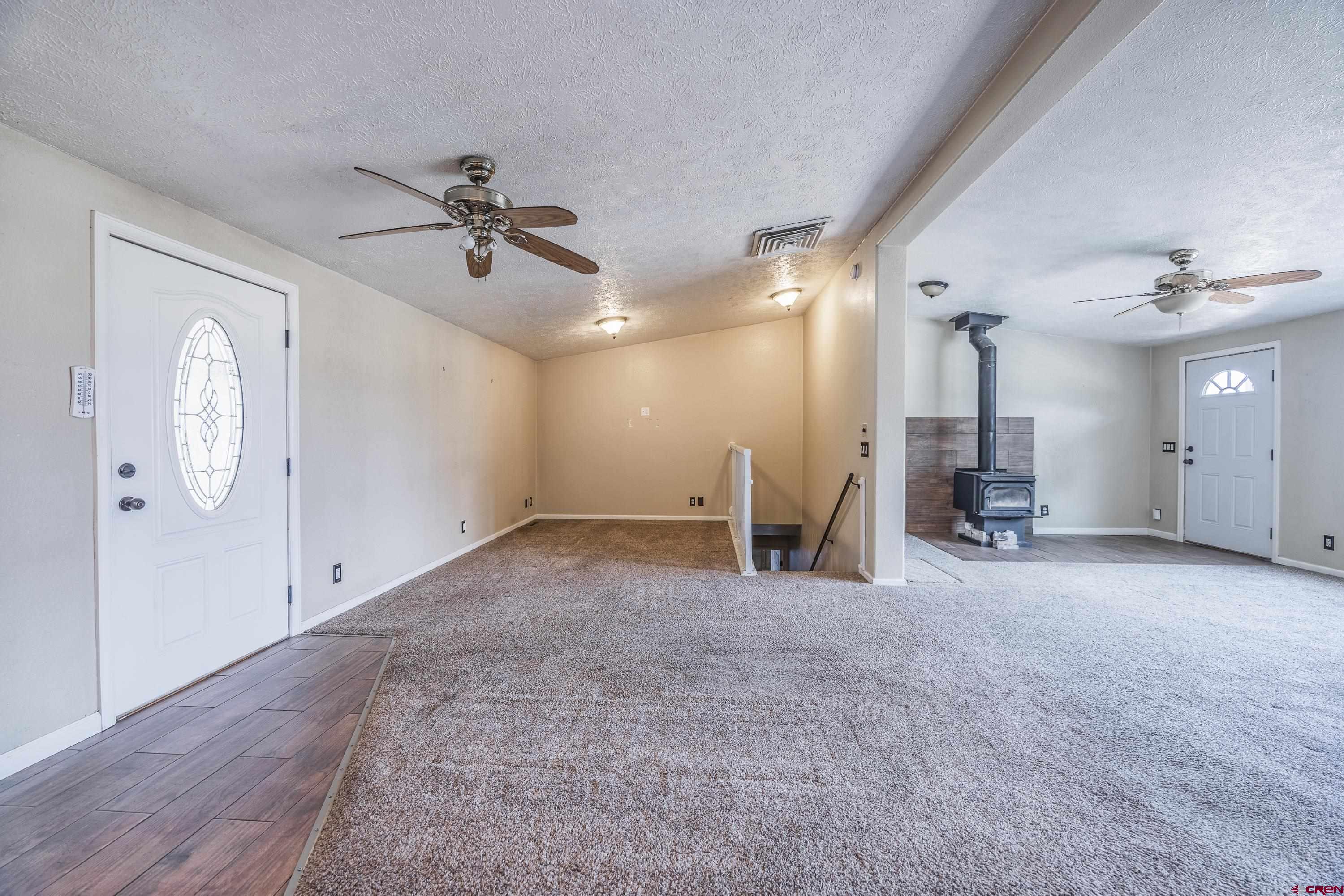 17377 Breeze Road Delta, CO 81416 - Photo 15 of 45 an empty room with ceiling fan and windows