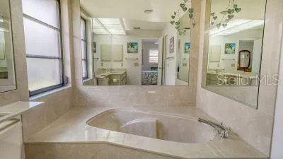 a bathroom with a tub shower and sink