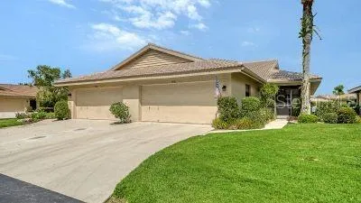 a front view of a house with a yard and potted plants