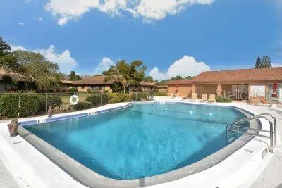 a view of a swimming pool with a yard