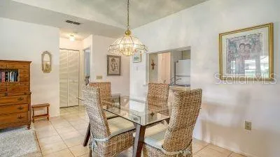 a view of a dining room with furniture and chandelier