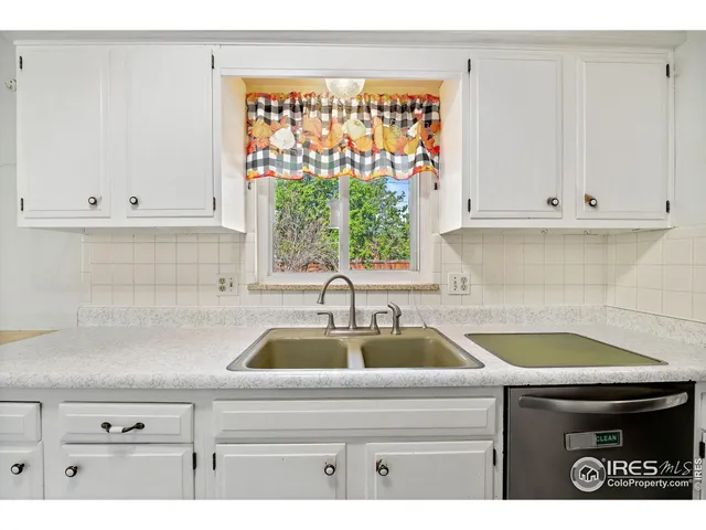 a kitchen with a sink and white cabinets