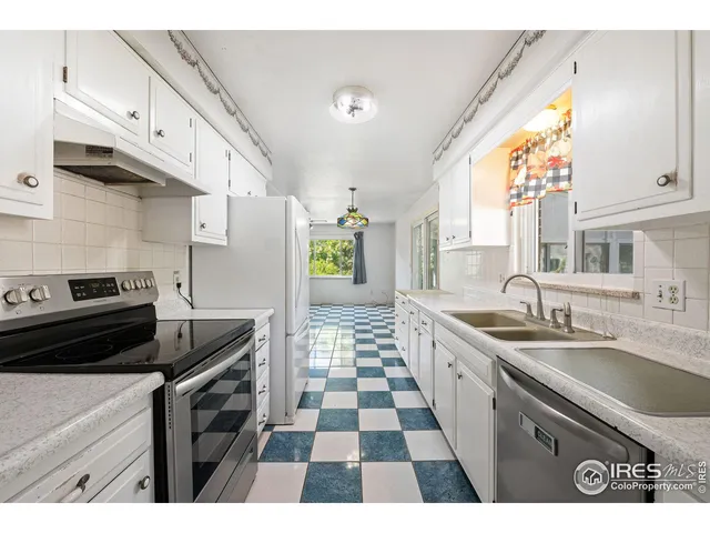 a kitchen with a sink a stove and a refrigerator