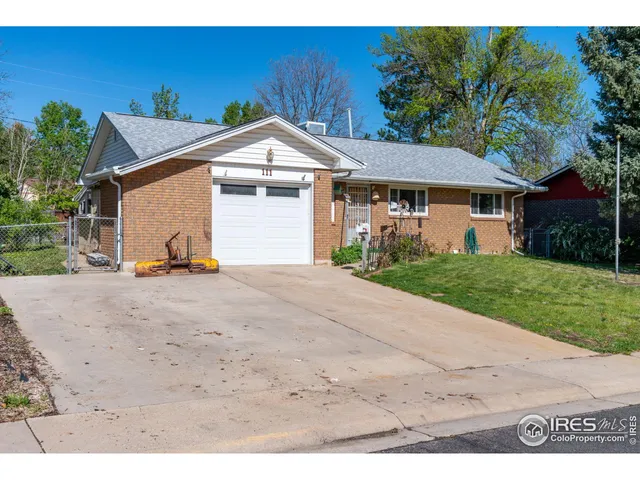 a view of a white house with a yard