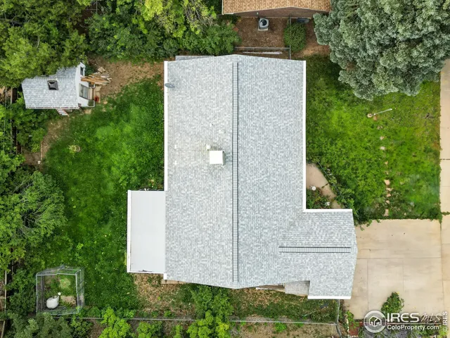 an aerial view of a house with a yard