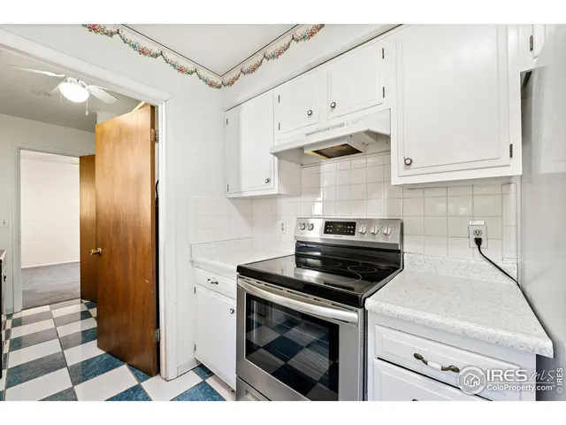 a kitchen with cabinets and appliances