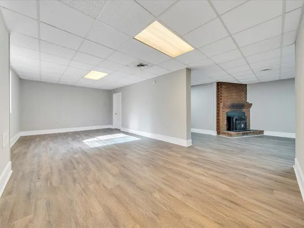a view of a room with wooden floor and a window
