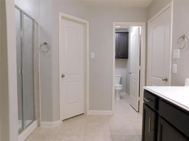 a bathroom with a tub sink vanity and mirror