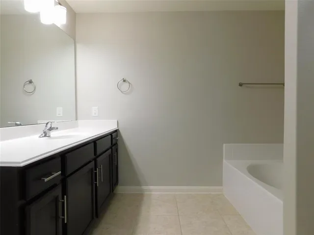 a white bath tub sitting next to a shower