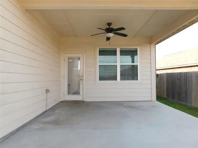 a view of backyard with wooden fence